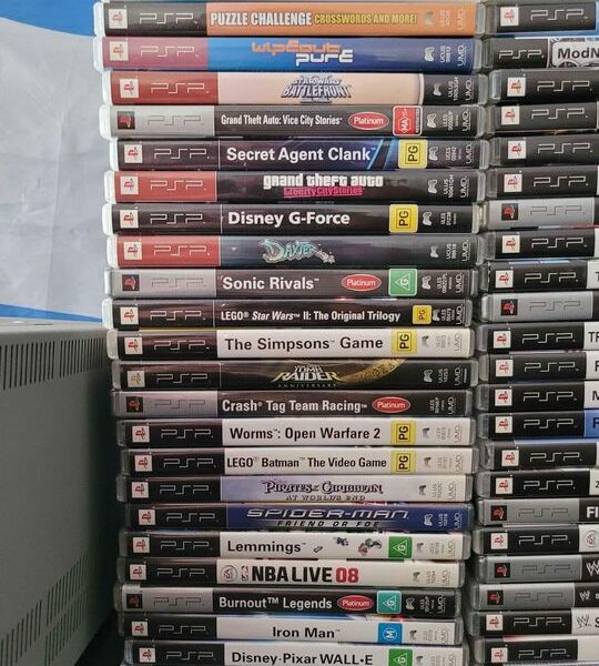 2 X PSP Consoles And 50 Games And 5 UMD Movies In Good Condition.